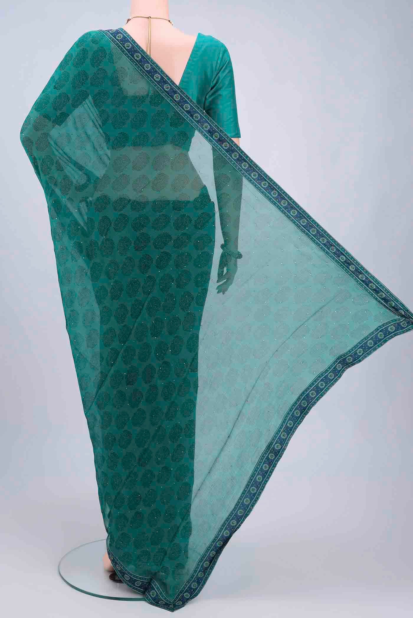 Flat view of Sea Green Chiffon Saree with Printed design on the body and Attached Border