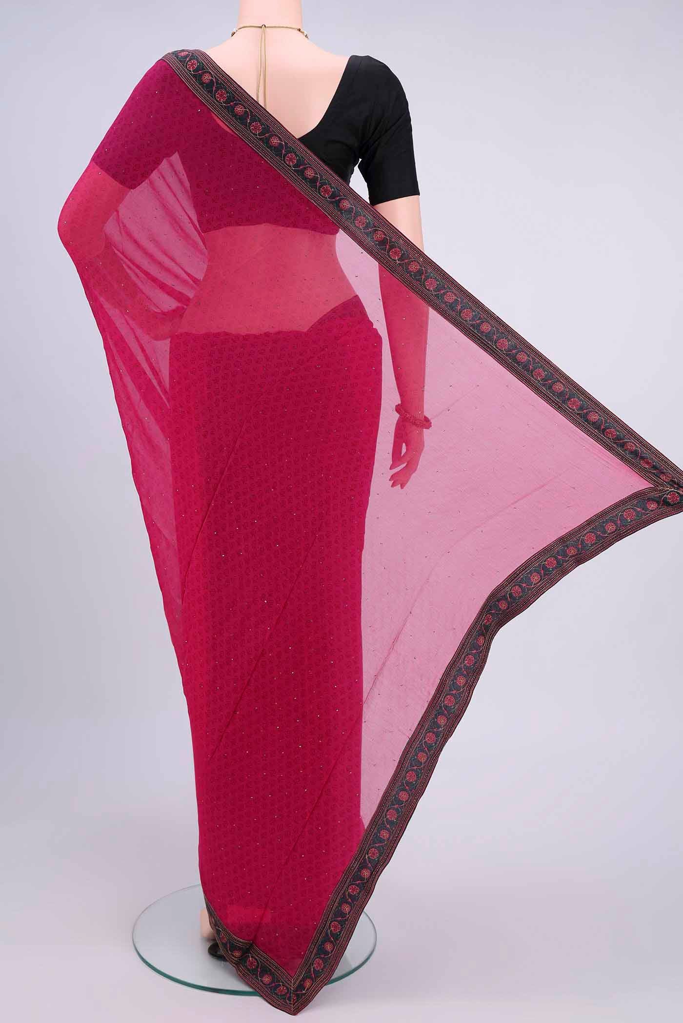 Flat view of Dark Pink Chiffon Saree with Printed design on the body and Attached Border