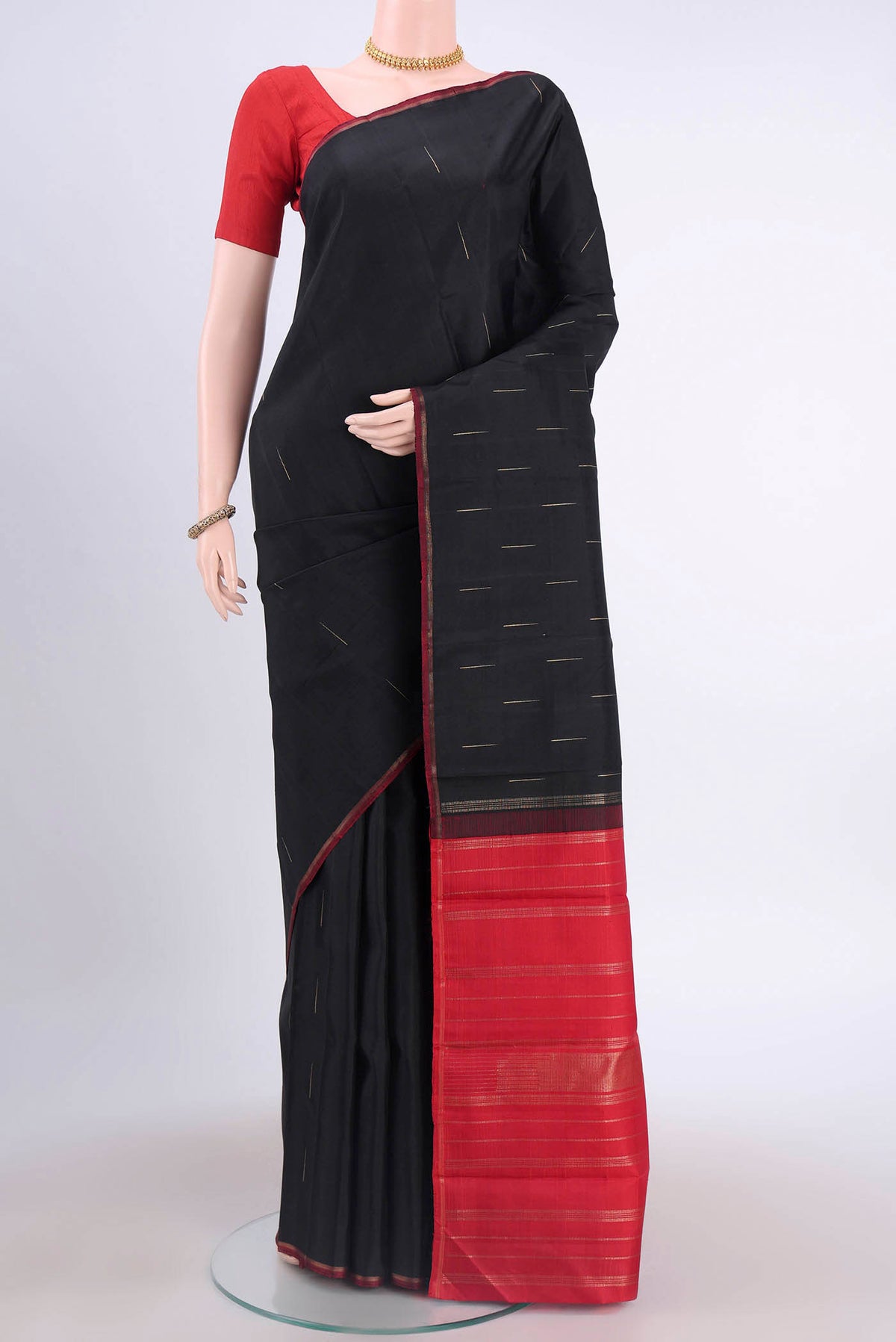 Black Kanchipuram Silk Saree with Zari Butta on the body and Zari Border displayed on a mannequin
