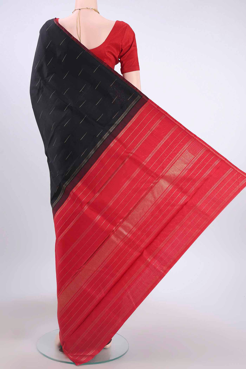 Flat view of Black Kanchipuram Silk Saree with Zari Butta on the body and Zari Border