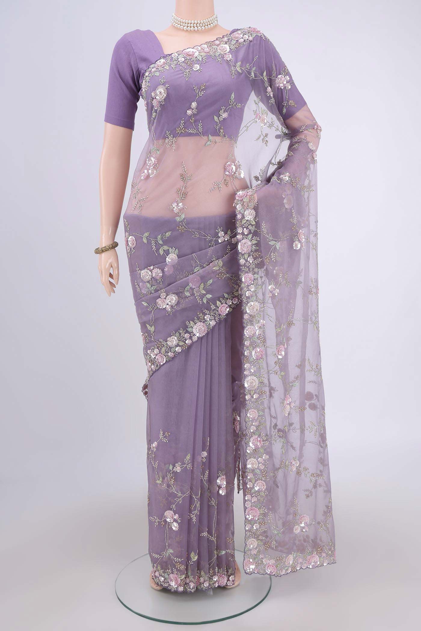 Violet Organza Silk Saree with Embroidery on the body and Embroidery Border.  displayed on a mannequin