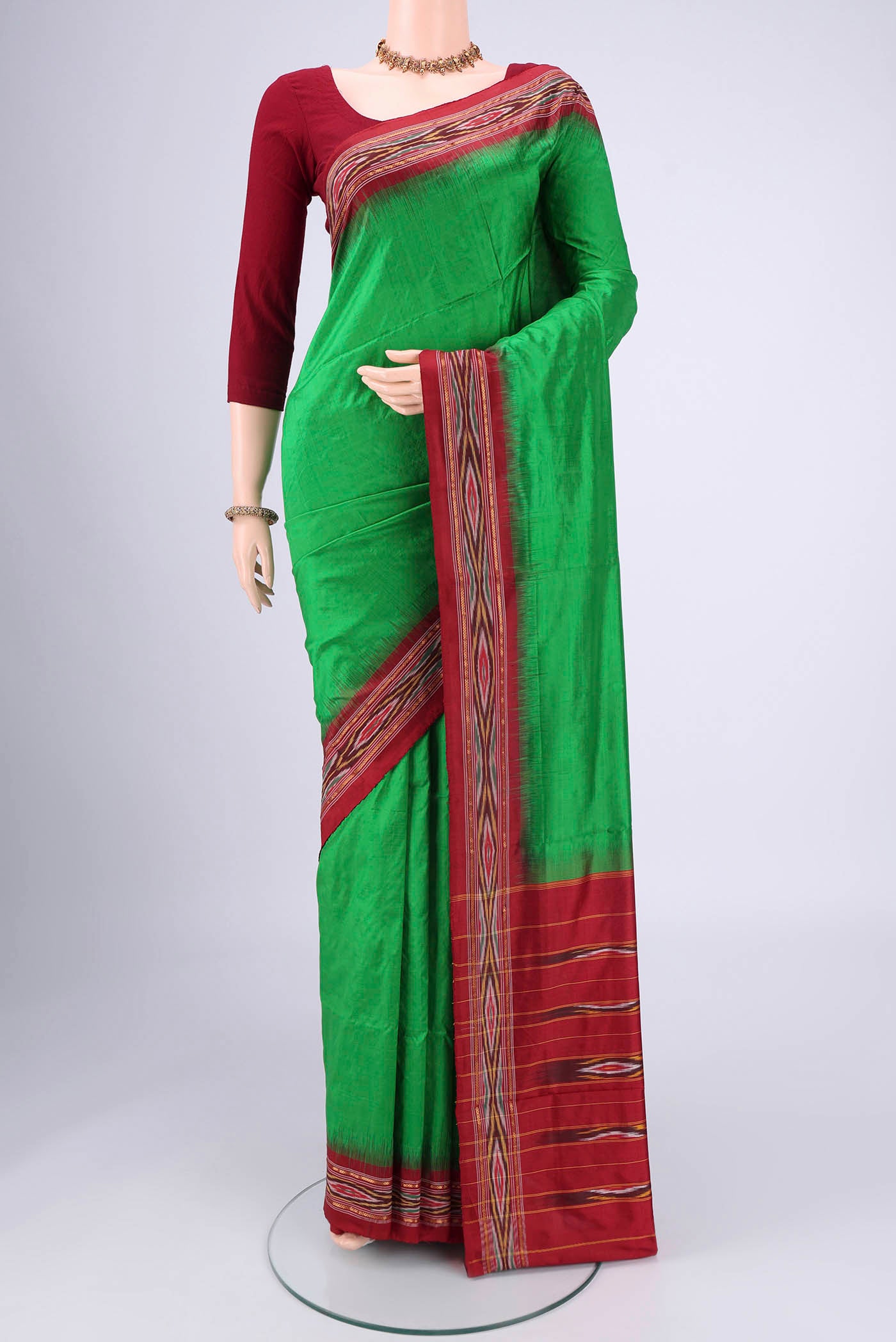 Green Pochampally Silk Saree with Plain Body and Ikat Border.  displayed on a mannequin