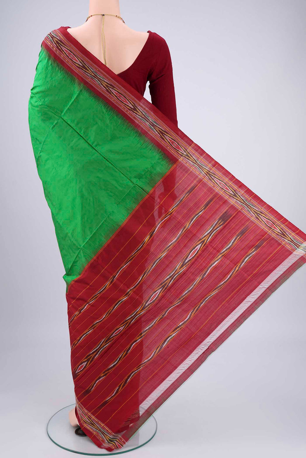 Flat view of Green Pochampally Silk Saree with Plain Body and Ikat Border. 