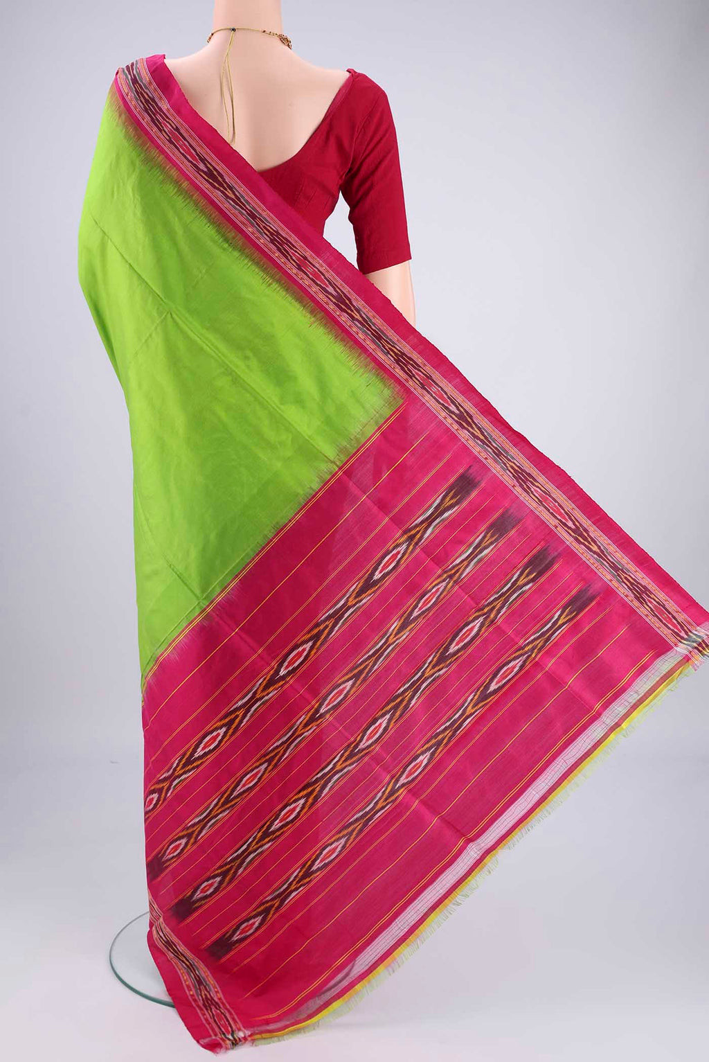 Flat view of Parrot Green Pochampally Silk Saree with Plain Body and Ikat Border. 