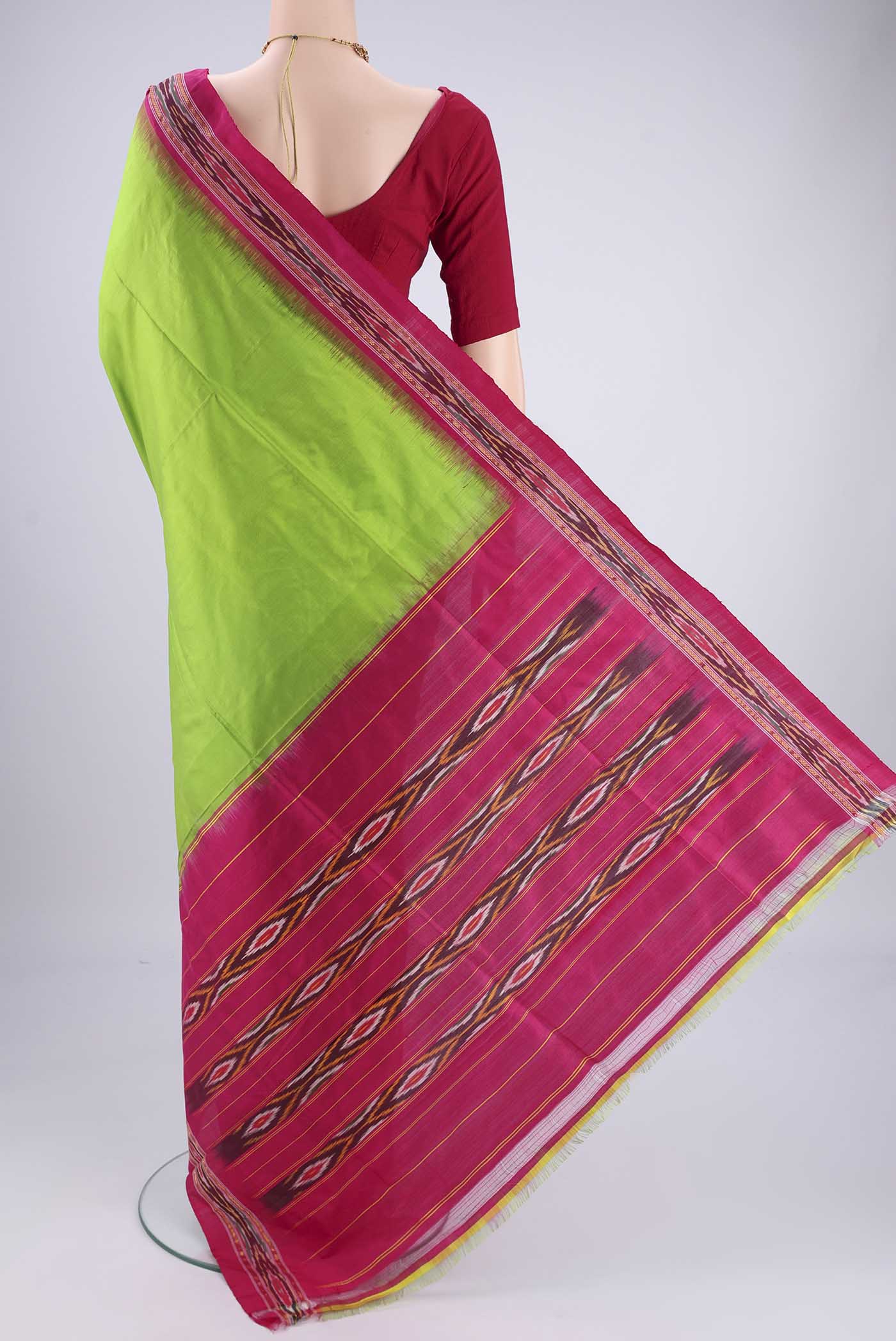 Flat view of Parrot Green Pochampally Silk Saree with Plain Body and Ikat Border. 