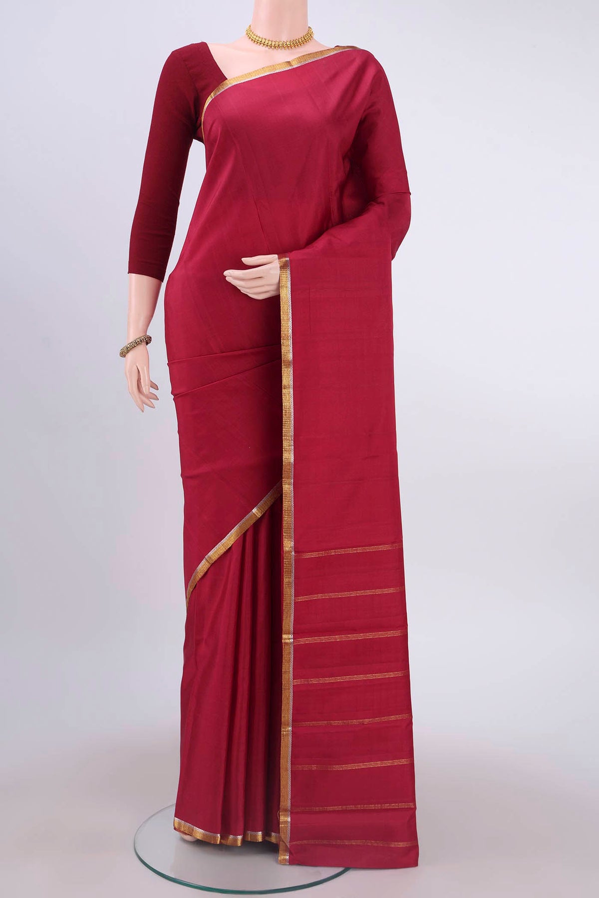 Maroon Dual Tone Kanchipuram Silk Saree with Plain Body and Zari Border displayed on a mannequin