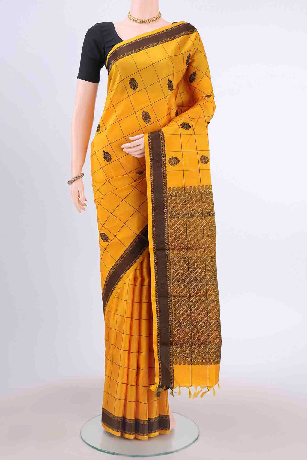 Yellow Kanchipuram Silk Saree with Checked design on the body and Thread Border displayed on a mannequin