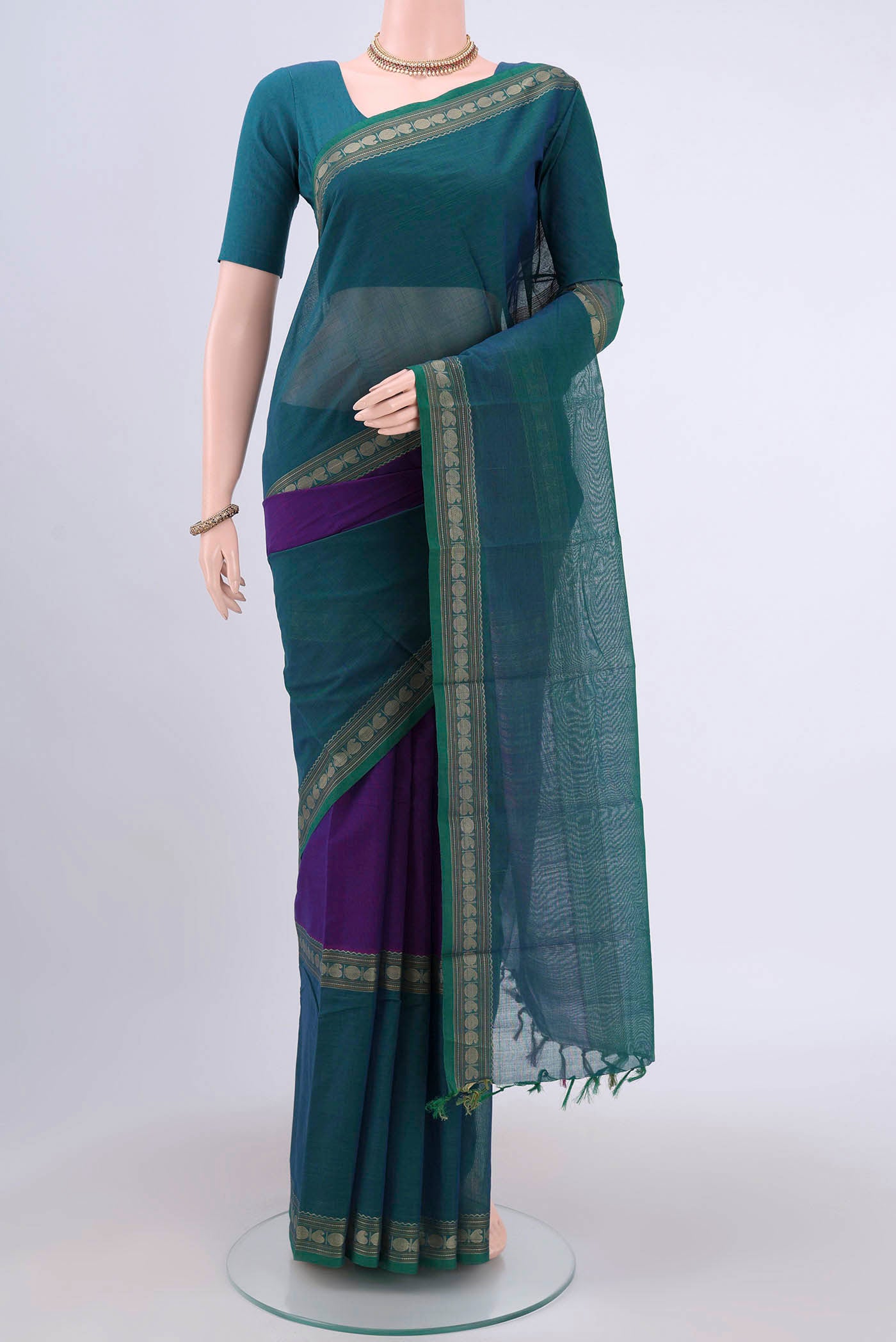 Magenta Kanchi Cotton Saree with Plain Body and Zari Border.  displayed on a mannequin