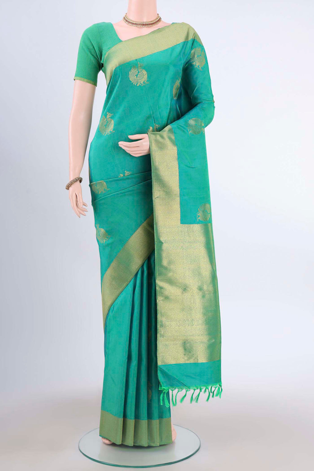 Sea Green Kanchipuram Silk Saree with Zari Butta on the body and Zari Border displayed on a mannequin