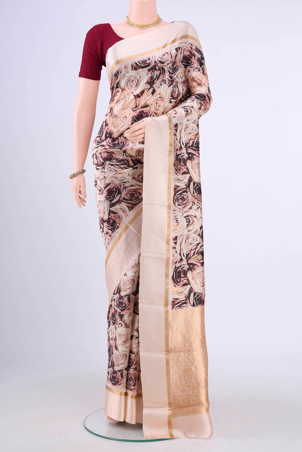 Rose Gold Printed Silk Saree with Printed design on the body and Zari Border displayed on a mannequin
