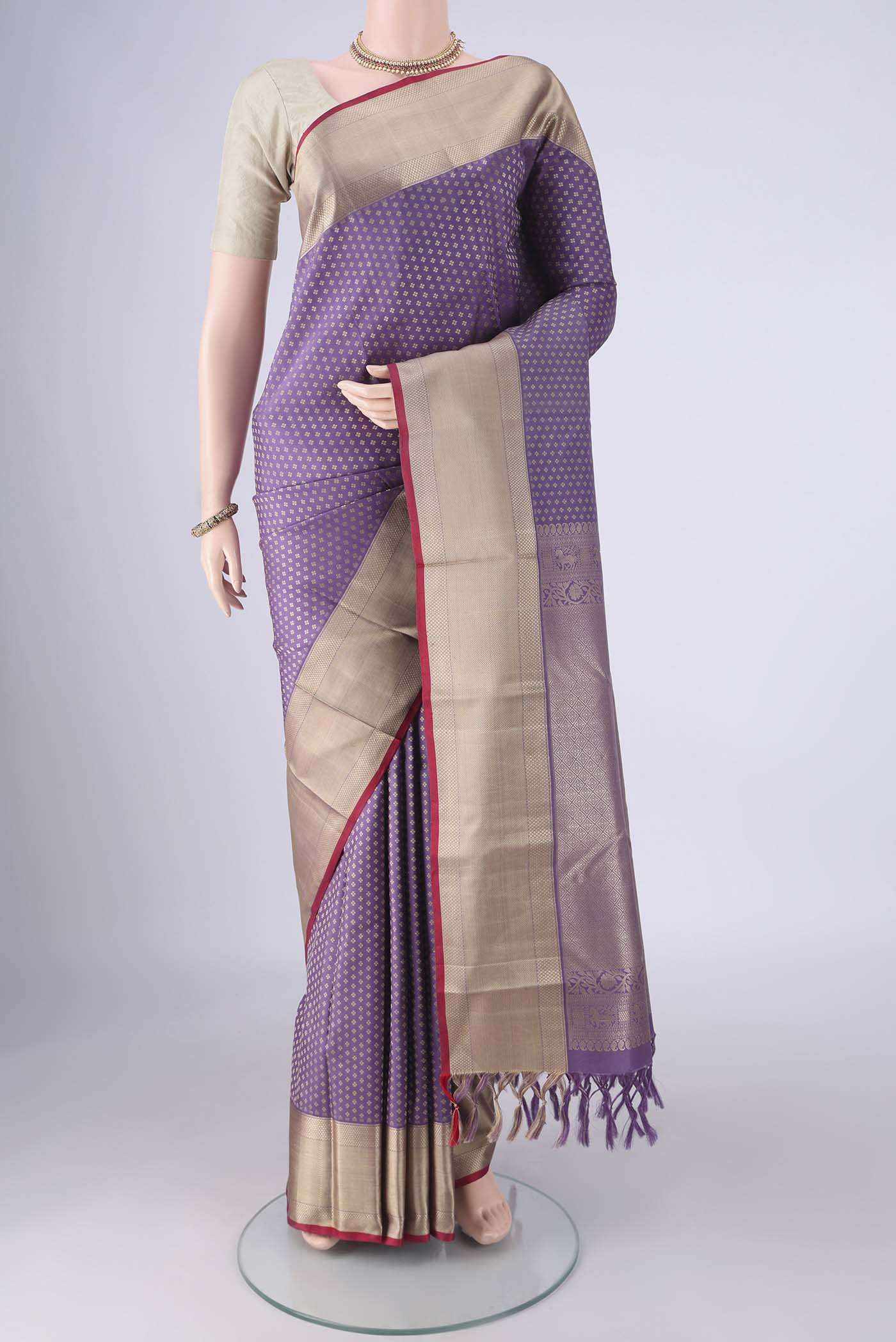 Lavender Kanchipuram Silk Saree with Jacquard design on the body and Thread Border.  displayed on a mannequin
