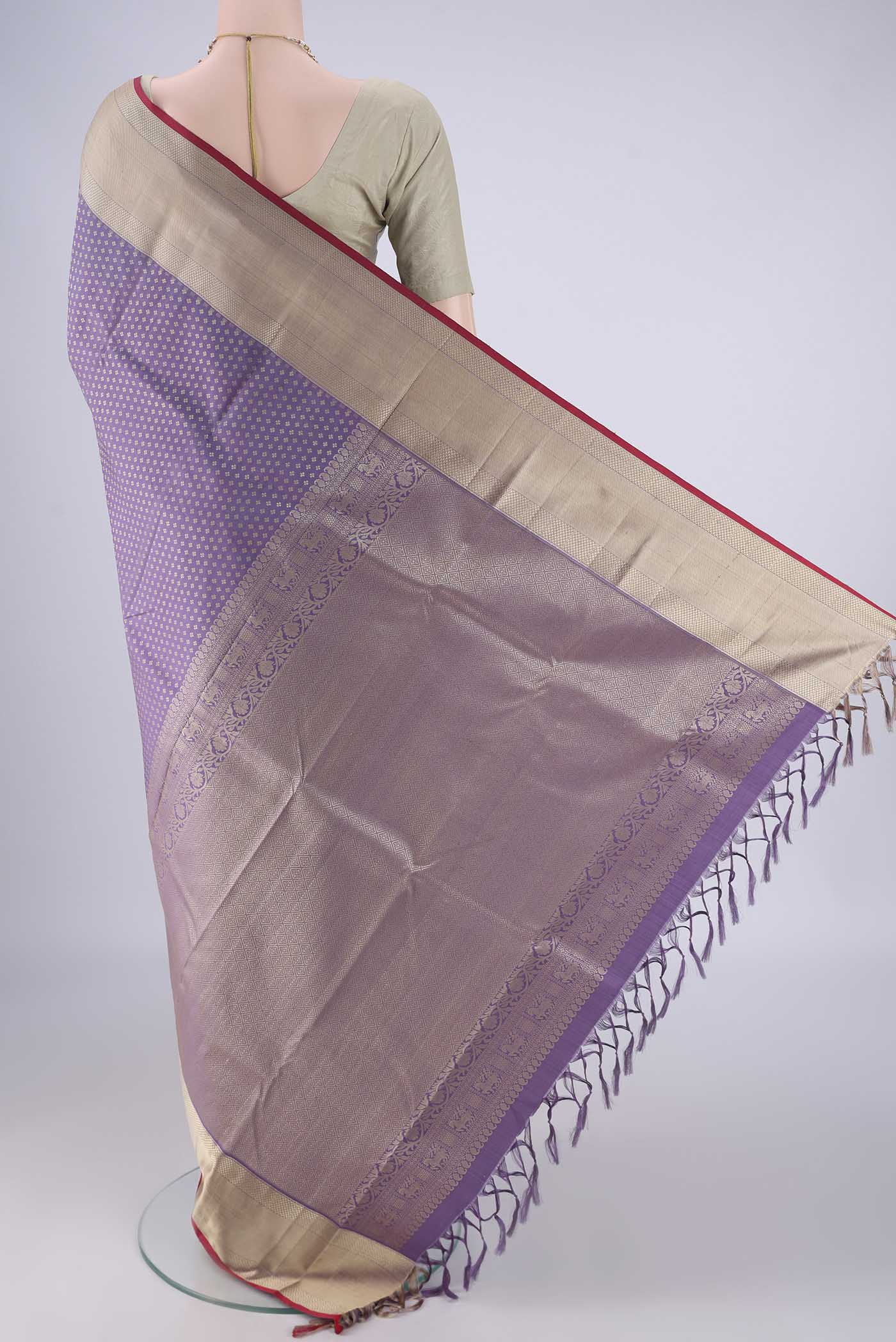 Flat view of Lavender Kanchipuram Silk Saree with Jacquard design on the body and Thread Border. 