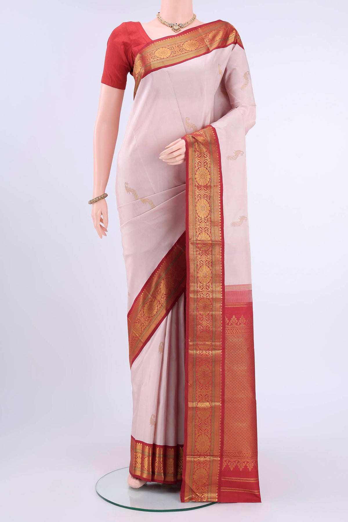 Rose pink Kanchipuram Silk Saree with Zari Butta on the body and Zari Border displayed on a mannequin