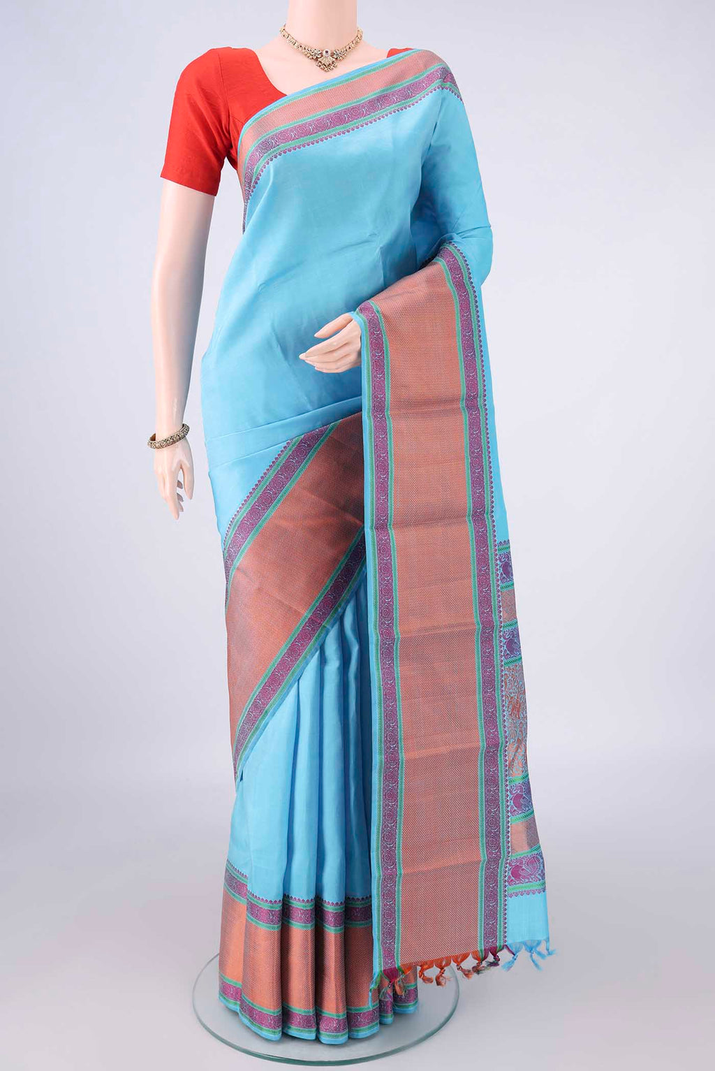 Pure Silk Sky Blue Kanjivaram Saree with Plain Body and Thread Border.  displayed on a mannequin