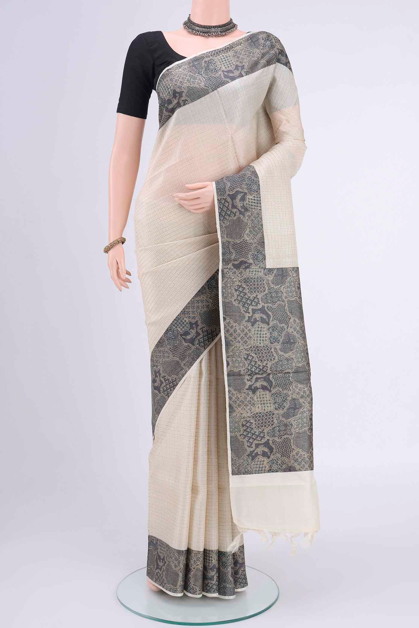 Off White Tussar Silk Saree with Zari Butta on the body and Printed Border displayed on a mannequin