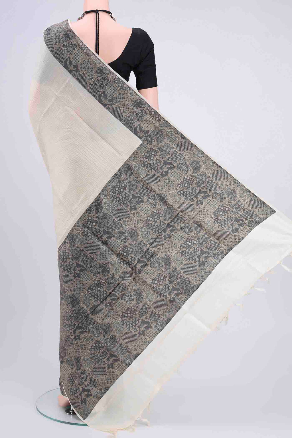 Flat view of Off White Tussar Silk Saree with Zari Butta on the body and Printed Border