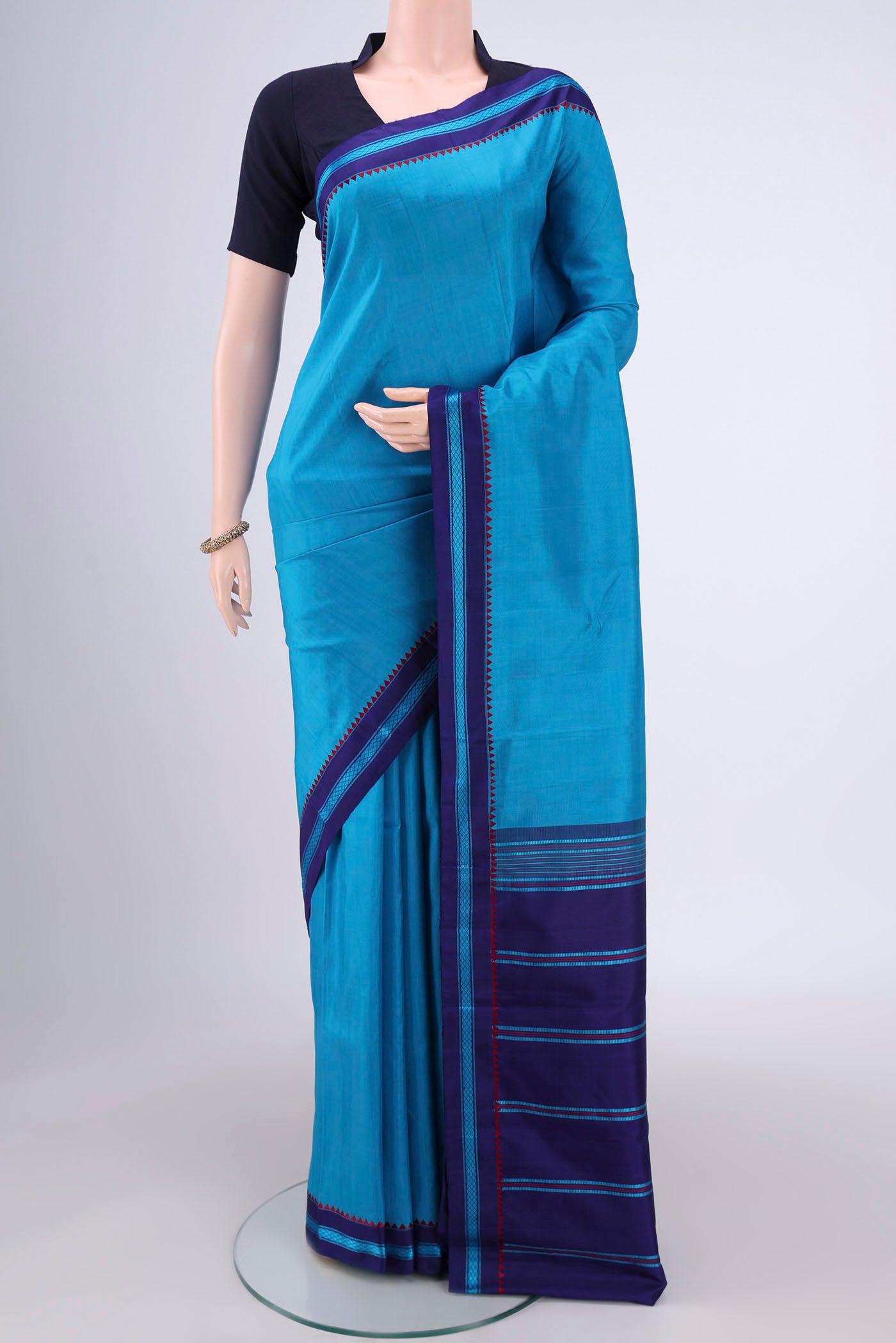 Blue Dual Tone Kanchipuram Silk Saree with Plain Body and Thread Border.  displayed on a mannequin