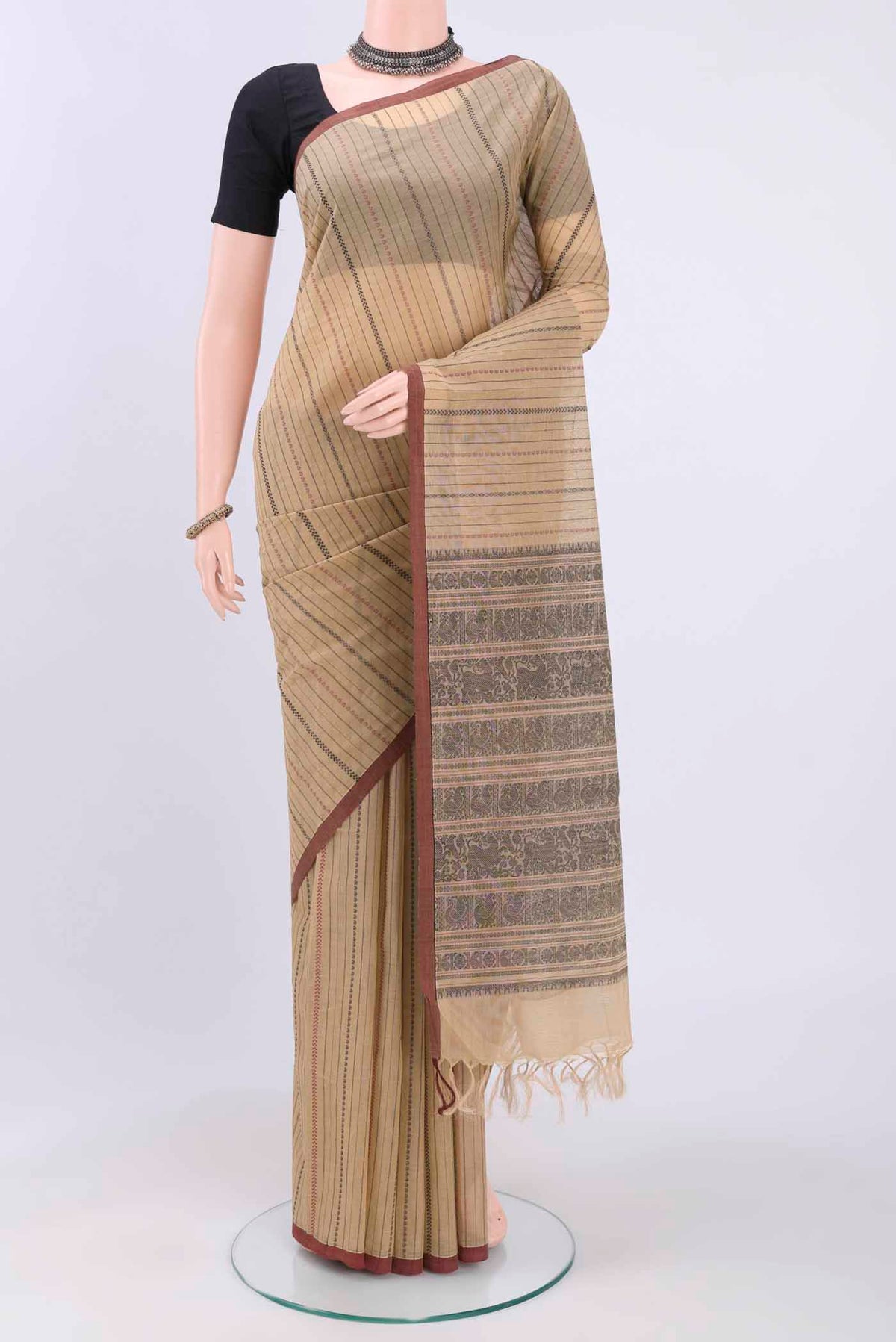Beige Kanchi Cotton Saree with Stripes on the body and Plain Border displayed on a mannequin