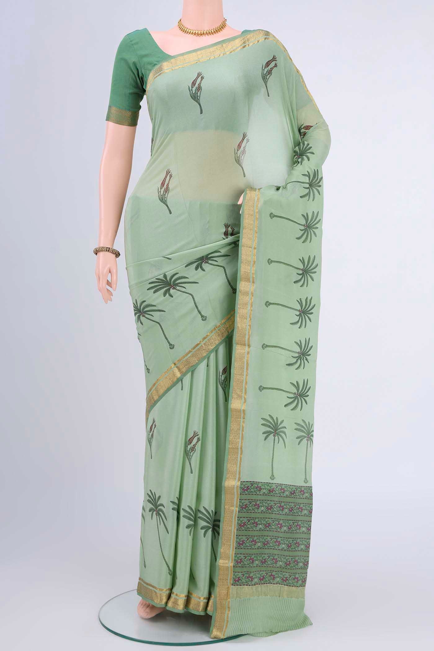 Sage Green Mysore Crepe Saree with Floral Print on the body and Printed Border displayed on a mannequin