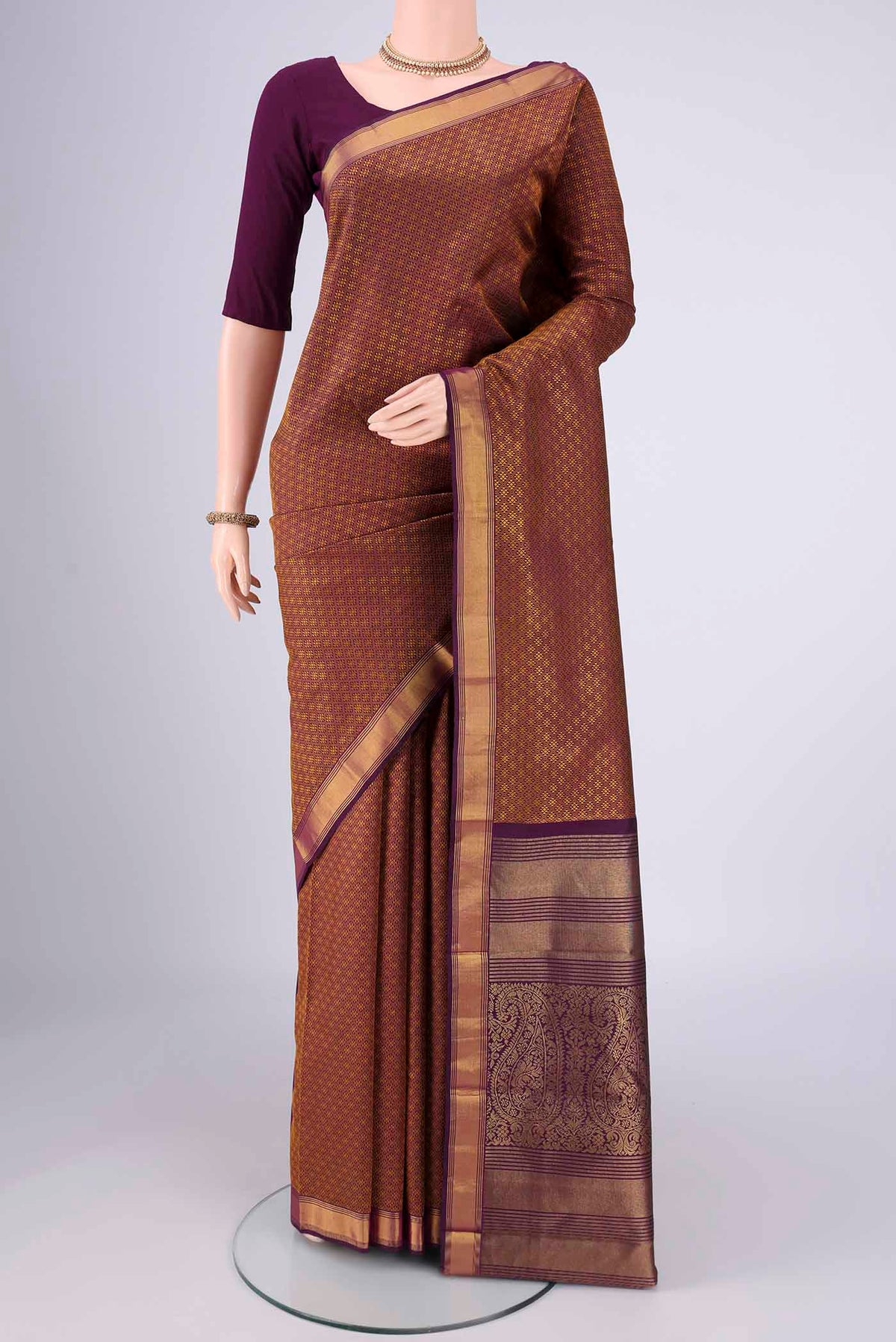 Pure Silk Pure Zari Burgundy Kanjivaram Saree with Jacquard design on the body and Zari Border.  displayed on a mannequin