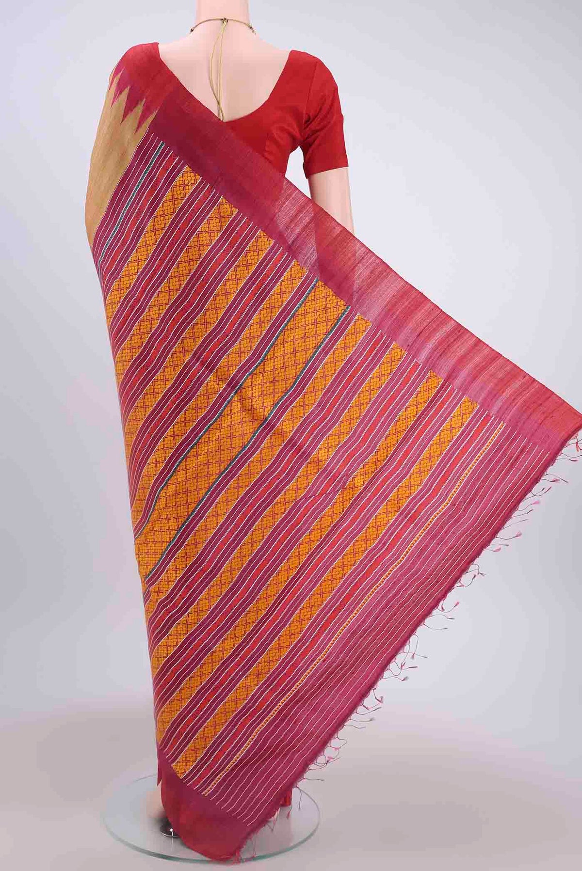 Flat view of Golden Tussar Silk Saree with Thread Butta on the body and Temple Border