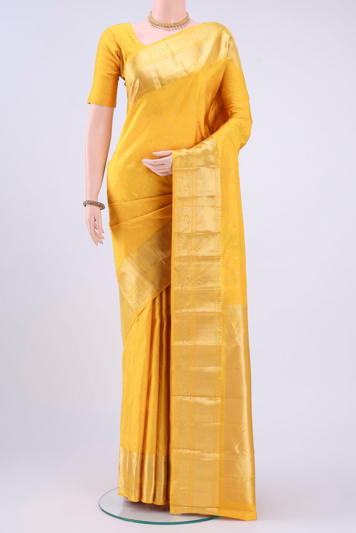 Lemon Yellow Nangavalli Silk [ Salem ] Saree with Zari Butta on the body and Zari Border displayed on a mannequin