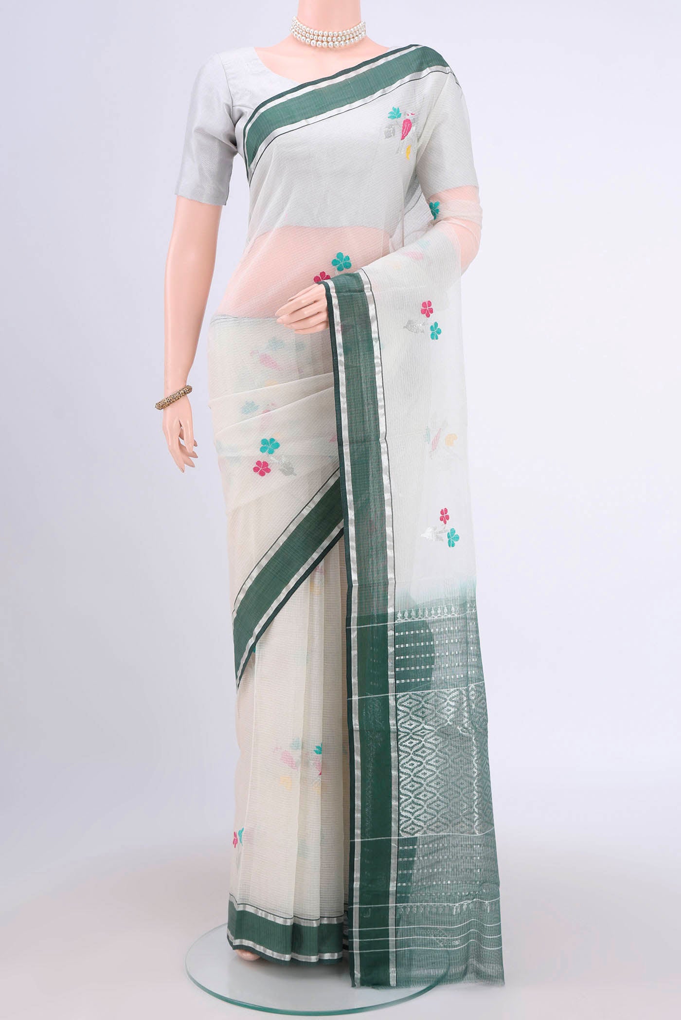 Pure Silk Pure Zari Off White Kota Cotton Saree with Zari And Thread Butta on the body and Zari Border.  displayed on a mannequin