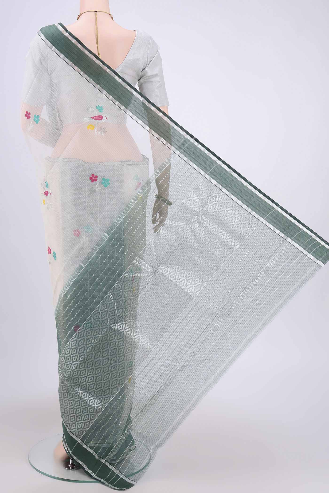 Flat view of Pure Silk Pure Zari Off White Kota Cotton Saree with Zari And Thread Butta on the body and Zari Border. 