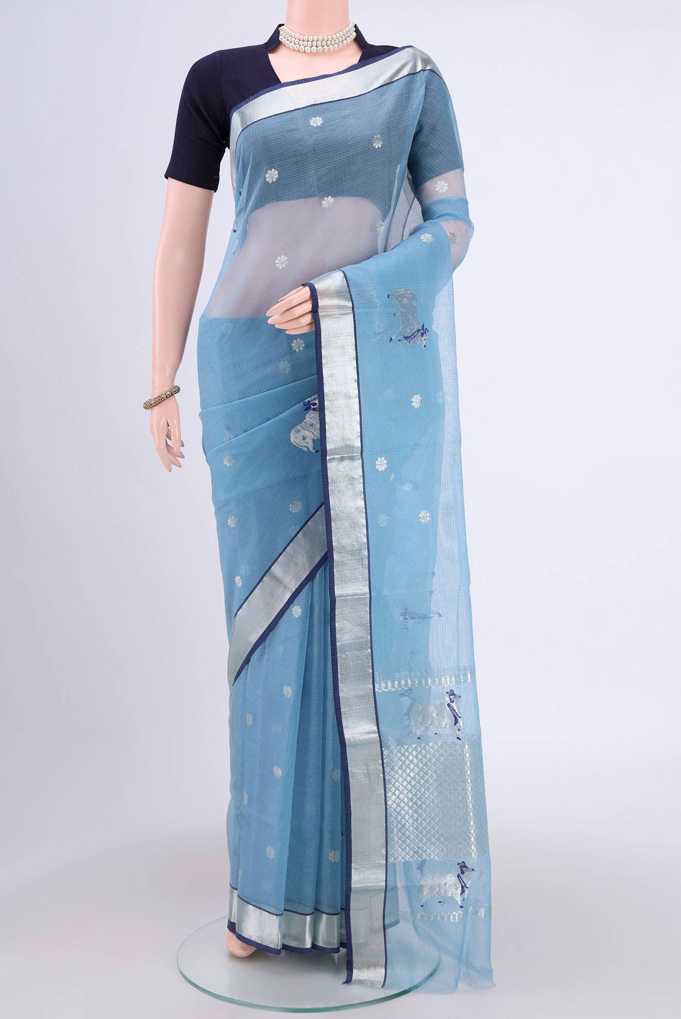 Pure Silk Pure Zari Light Blue Kota Cotton Saree with Zari And Thread Butta on the body and Zari Border.  displayed on a mannequin