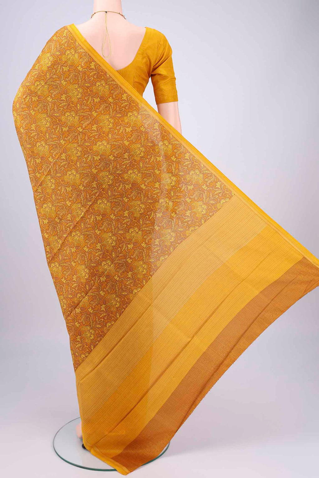 Flat view of Mustard Printed Silk Saree with Floral Print on the body and Printed Border. 