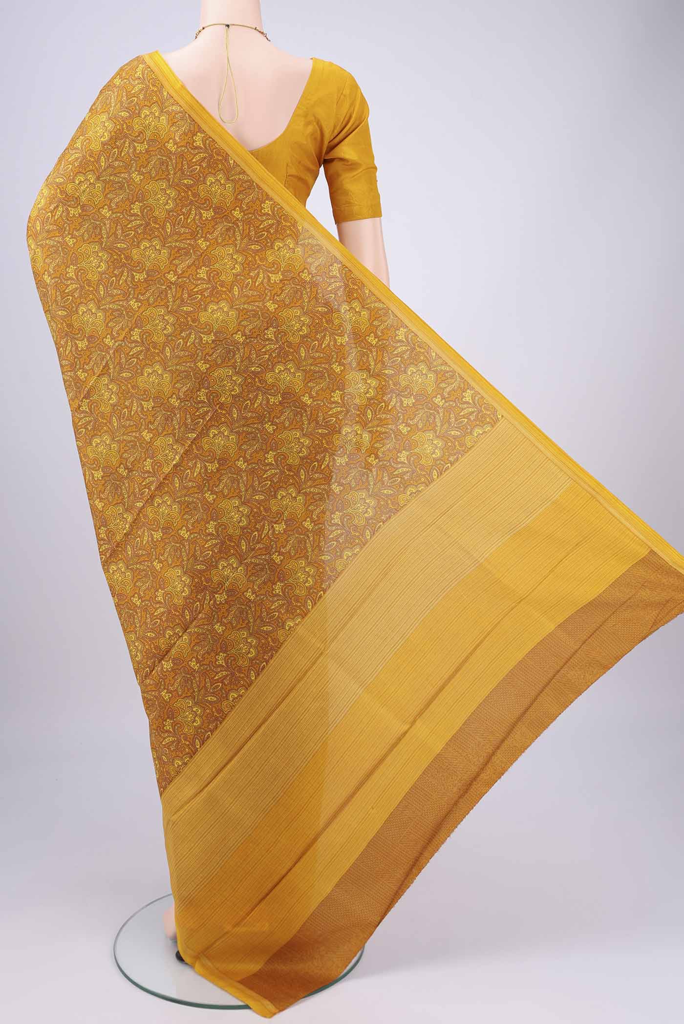 Flat view of Mustard Printed Silk Saree with Floral Print on the body and Printed Border. 