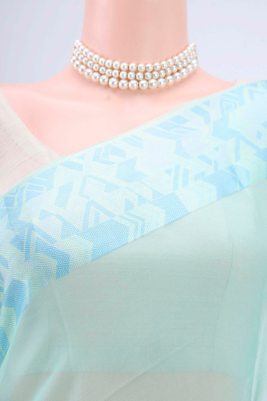 Border image of Turquoise Mysore Chiffon Saree with Plain Body and Printed Border. 