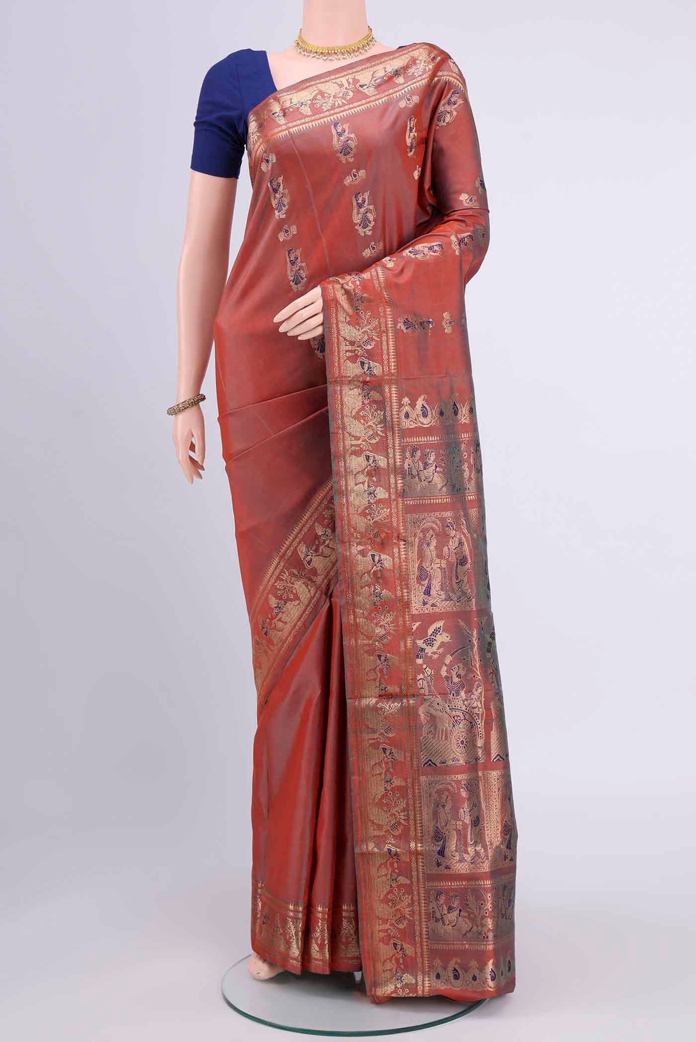 Rust Dual Tone Baluchari Silk Saree with Zari And Thread Butta on the body and Zari Border displayed on a mannequin