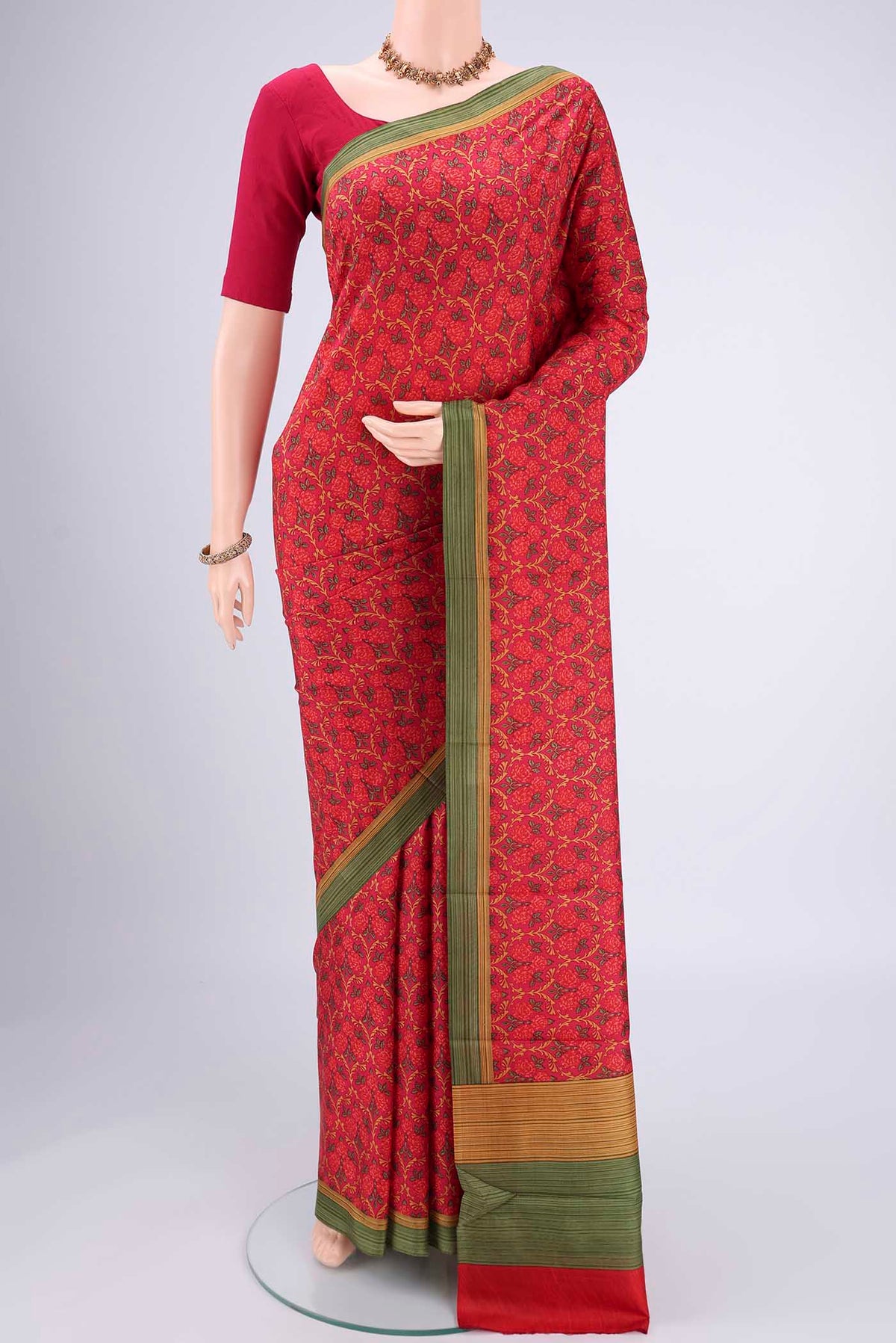 Rani Pink Printed Silk Saree with Floral Print on the body and Printed Border.  displayed on a mannequin