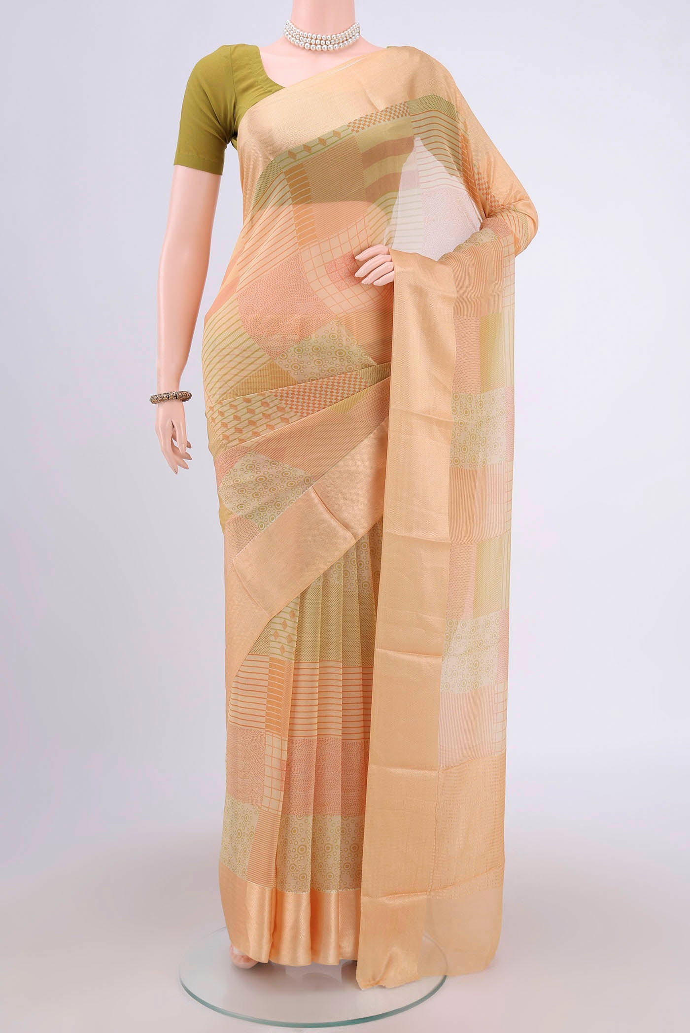 Beige Mysore Chiffon Saree with Printed design on the body and Printed Border.  displayed on a mannequin