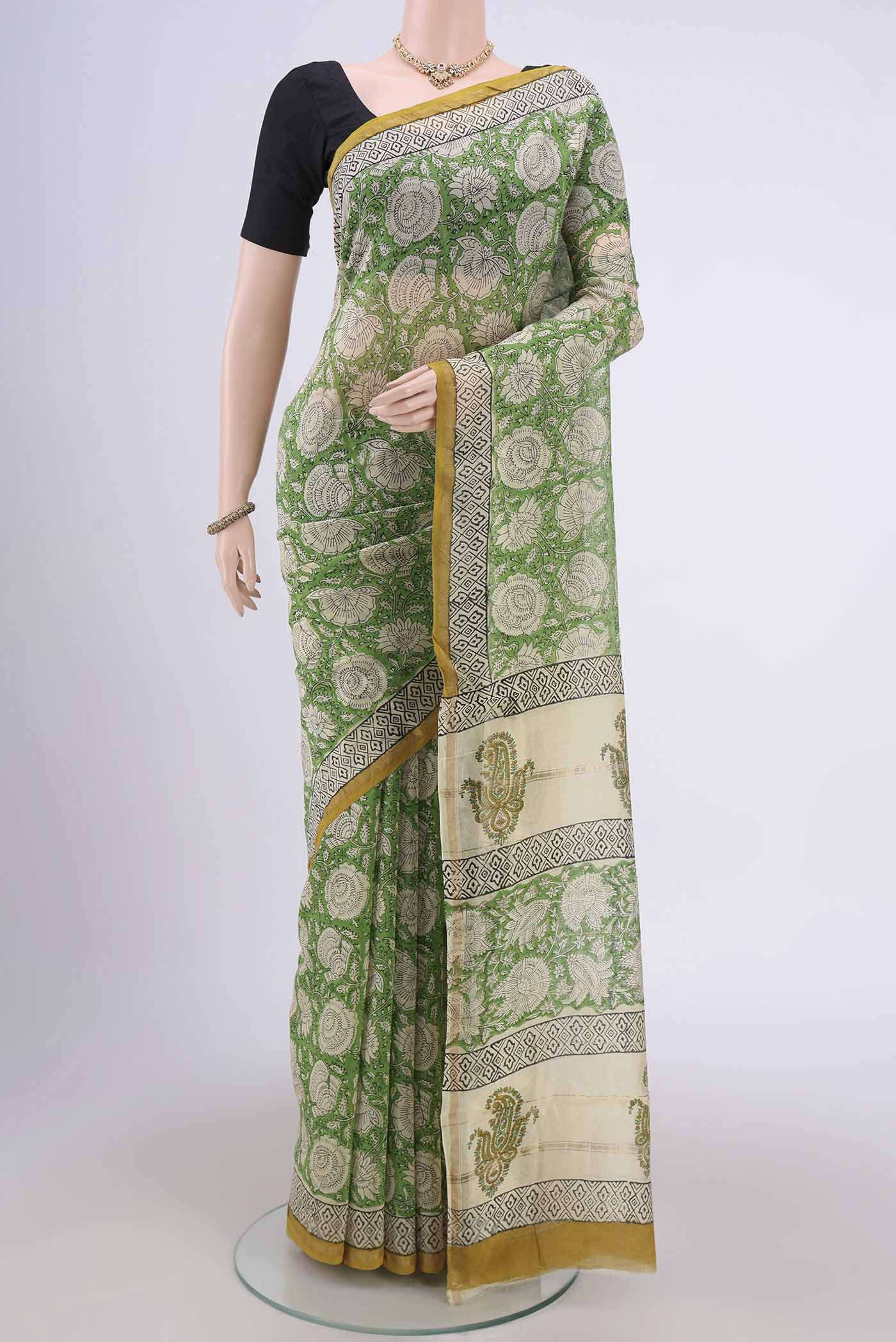 Light Green Chanderi Silk Cotton Saree with Printed design on the body and Zari Border.  displayed on a mannequin