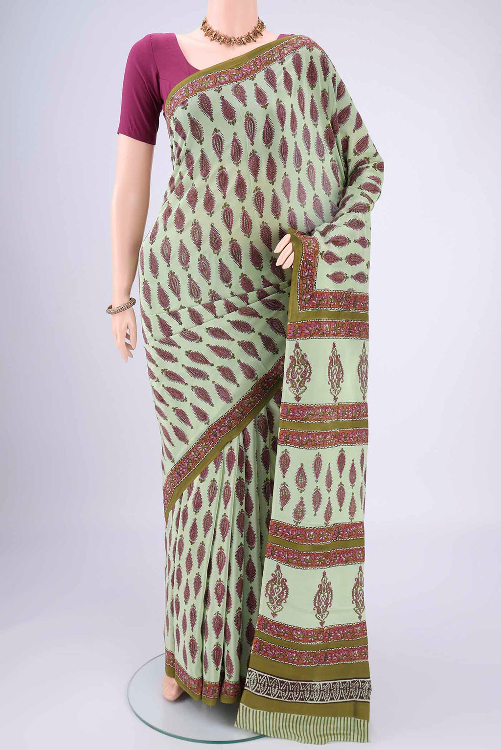 Mint Green Mysore Crepe Saree with Floral Print on the body and Zari Border.  displayed on a mannequin