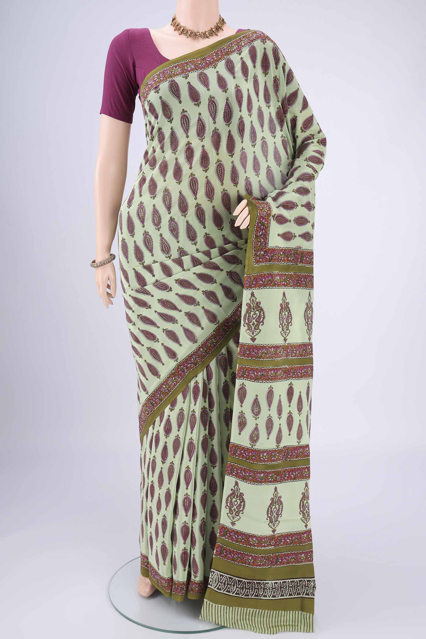 Mint Green Mysore Crepe Saree with Floral Print on the body and Zari Border.  displayed on a mannequin