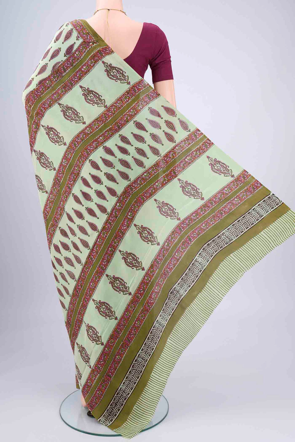 Flat view of Mint Green Mysore Crepe Saree with Floral Print on the body and Zari Border. 