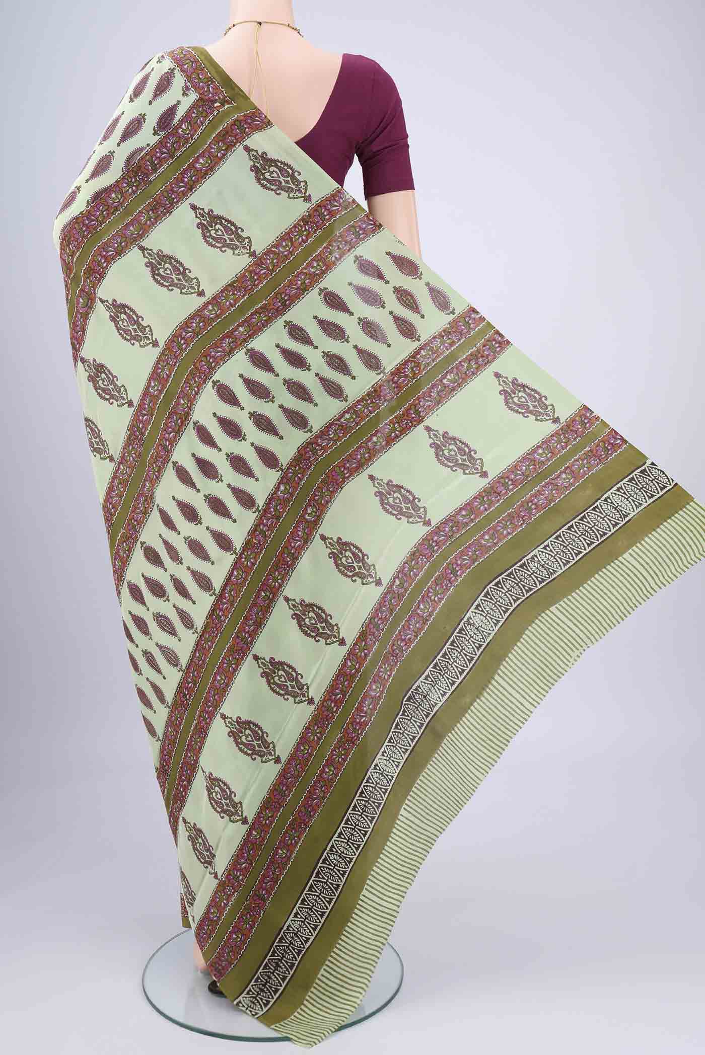 Flat view of Mint Green Mysore Crepe Saree with Floral Print on the body and Zari Border. 