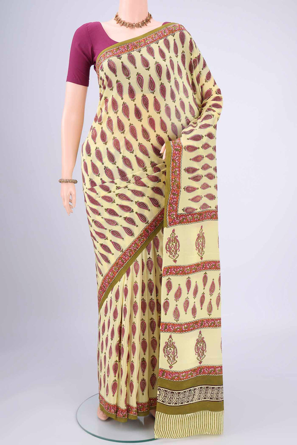 Lemon Yellow Mysore Crepe Saree with Floral Print on the body and Zari Border.  displayed on a mannequin