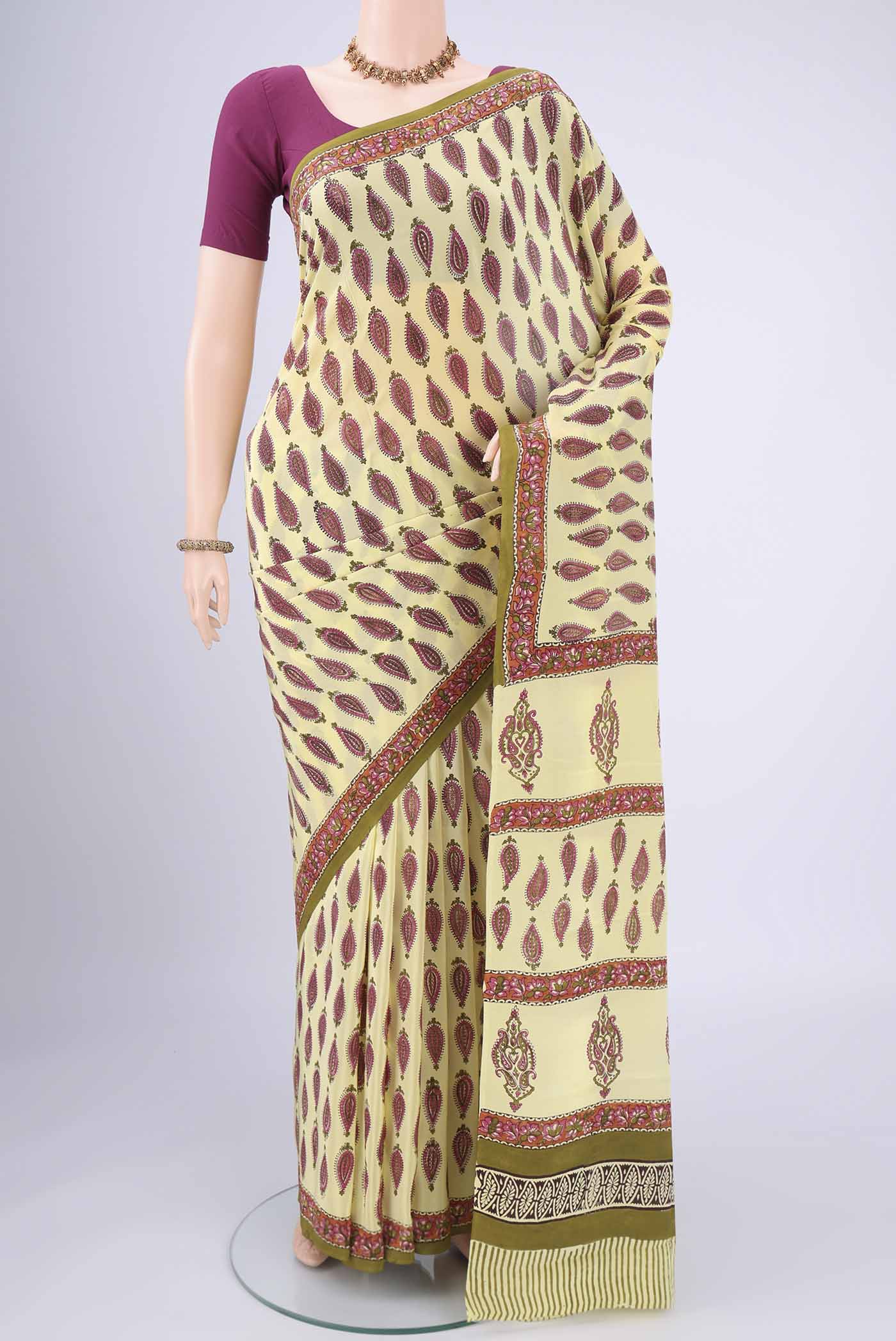 Lemon Yellow Mysore Crepe Saree with Floral Print on the body and Zari Border.  displayed on a mannequin