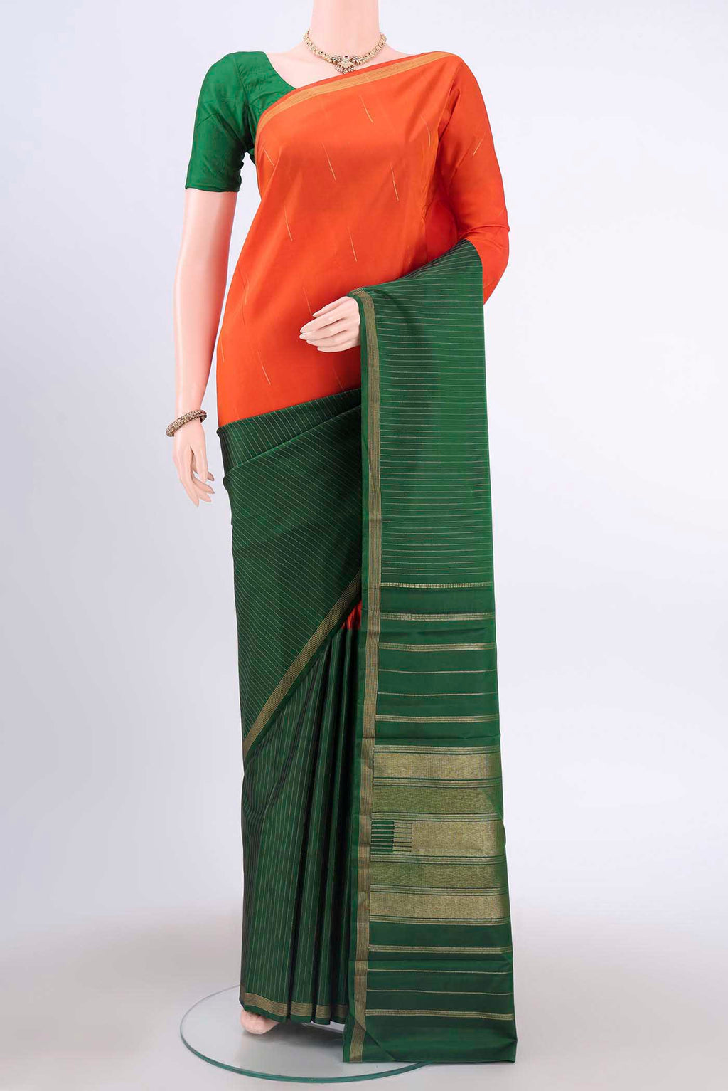 Orange Kanchipuram Silk Saree with Half And Half on the body and Plain Border displayed on a mannequin