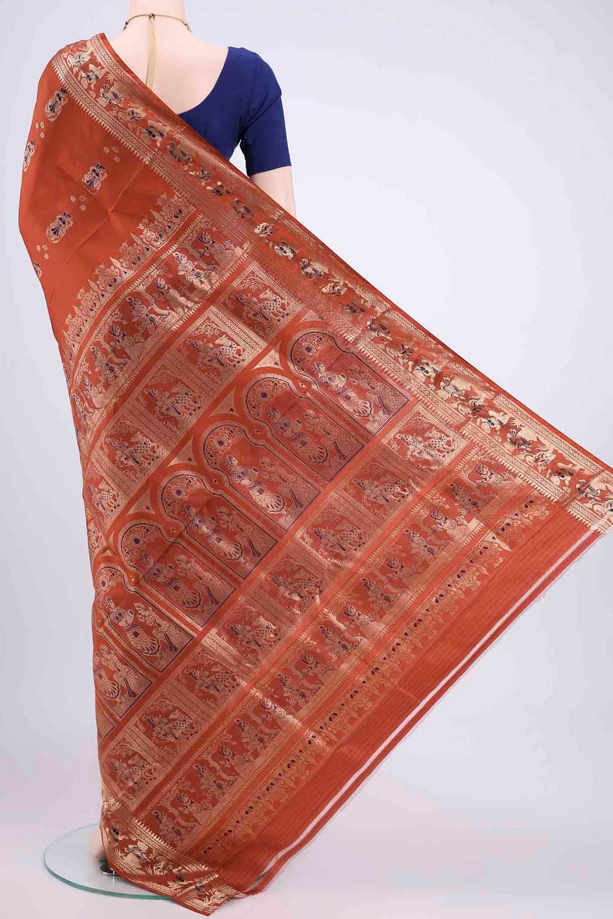 Flat view of Rust Baluchari Silk Saree with Zari Butta on the body and Zari Border