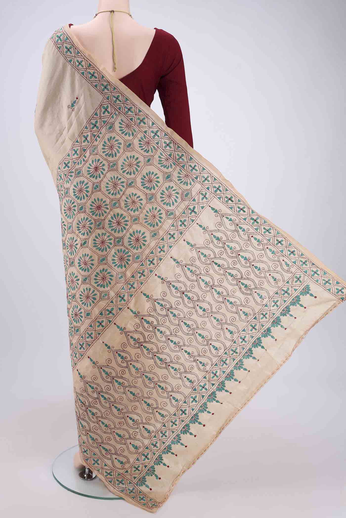 Flat view of Beige Tussar Silk Saree with Kantha Work on the body and Embroidery Border. 