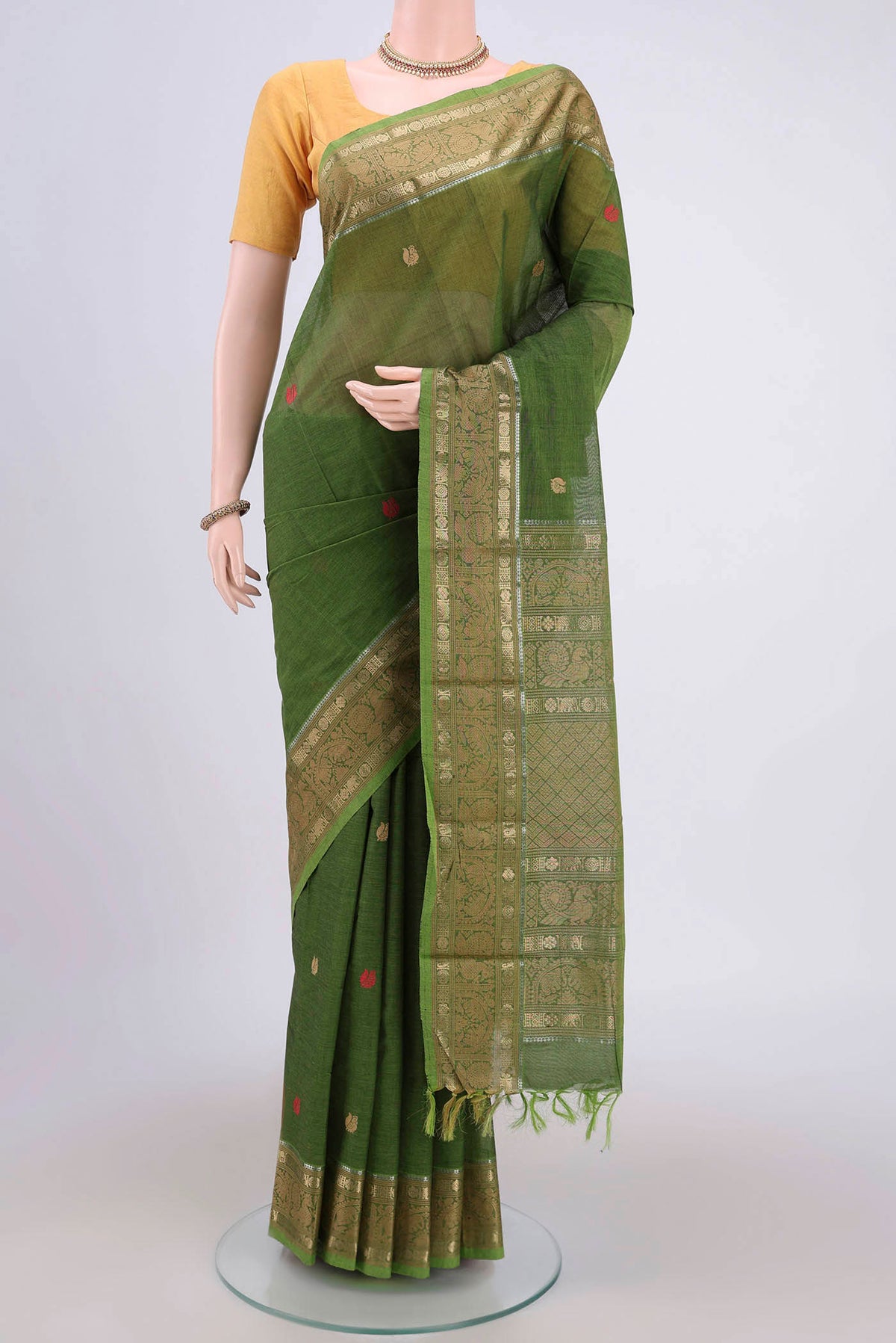 Green Kanchi Cotton Saree with Plain Body and Zari Border.  displayed on a mannequin