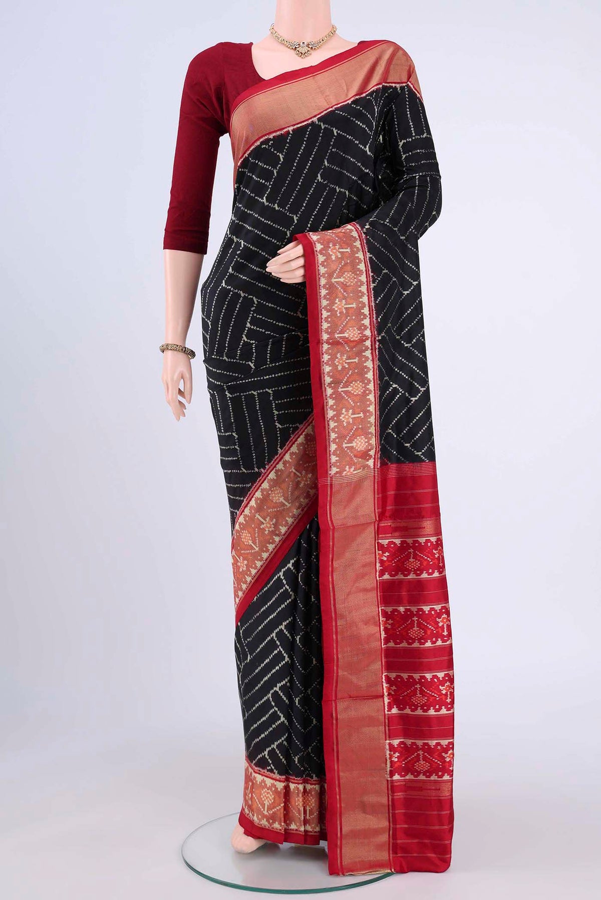 Black Pochampally Silk Saree with Ikat design on the body and Zari Border displayed on a mannequin