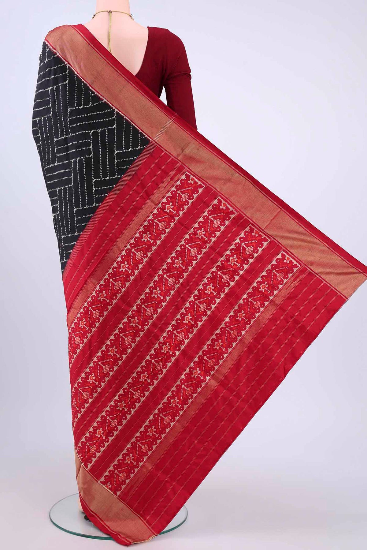Flat view of Black Pochampally Silk Saree with Ikat design on the body and Zari Border