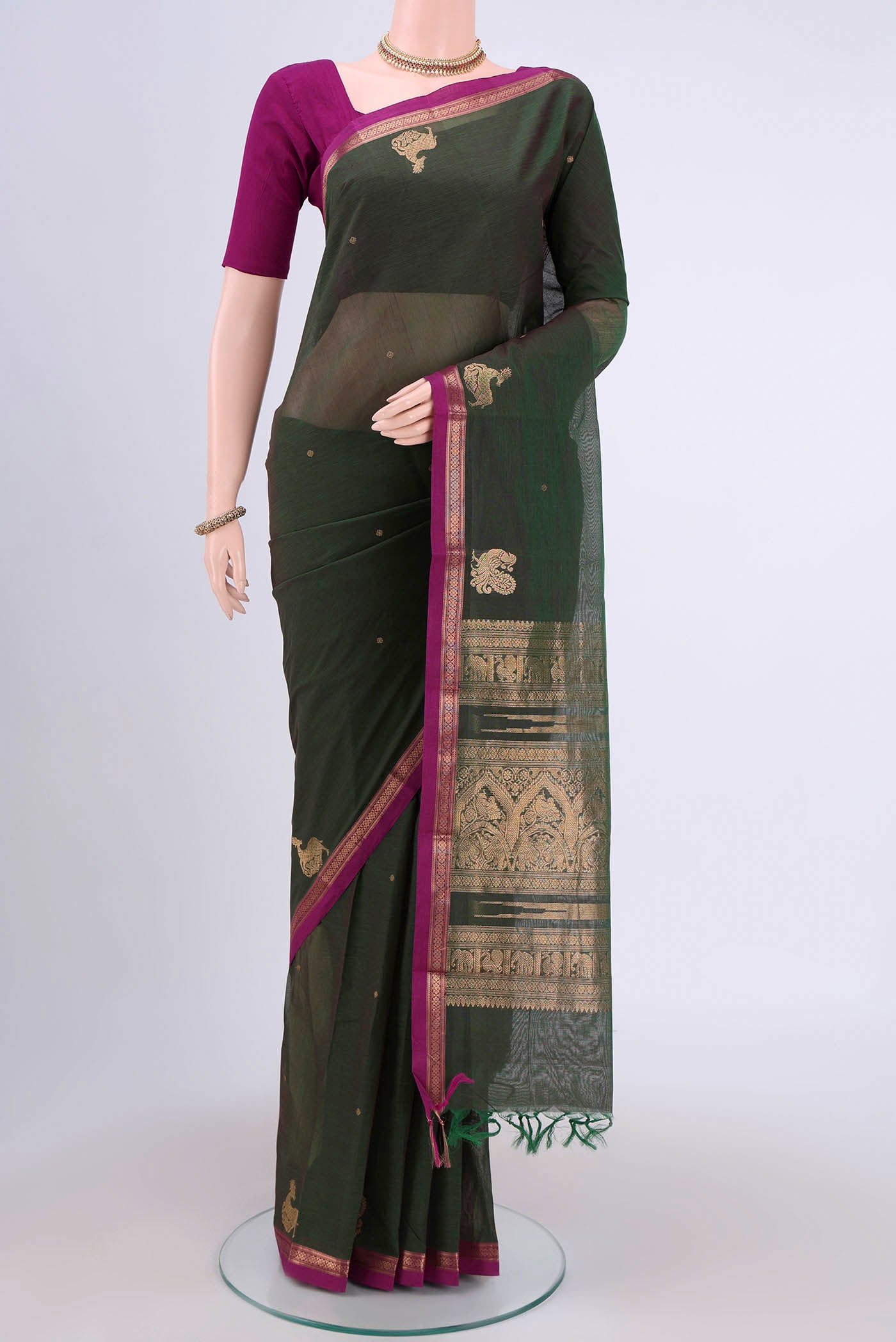 Green Kanchi Cotton Saree with Zari Butta on the body and Zari Border.  displayed on a mannequin