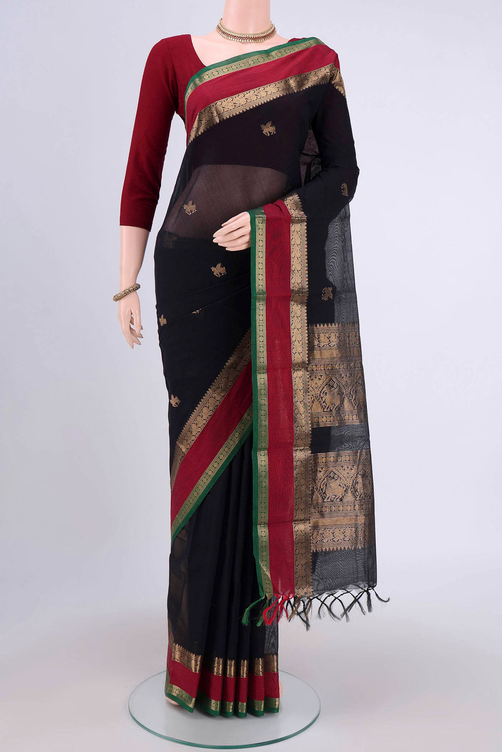 Black Kanchi Cotton Saree with Zari Butta on the body and Zari Border.  displayed on a mannequin